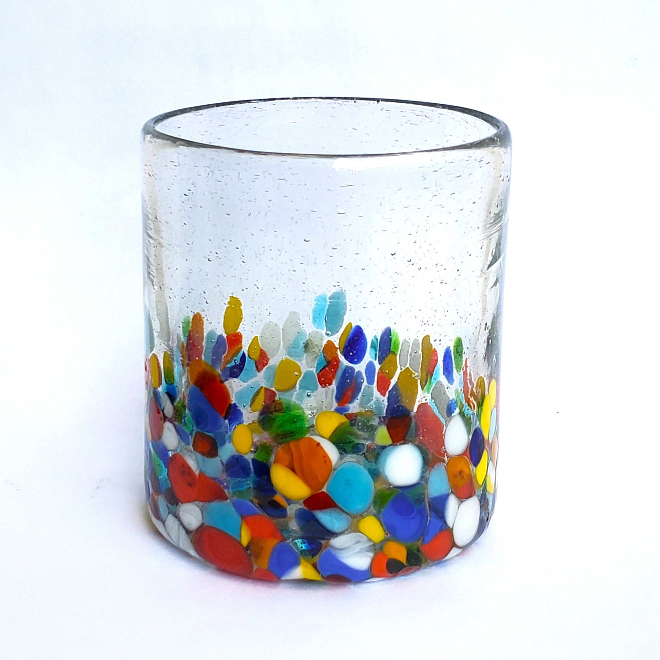 Novedades / Clear & Confetti 9 oz Short Tumblers (set of 6) / Our Clear & Confetti Glassware combines the best of two worlds: clear, thick, sturdy handcrafted glass on top, meets the colorful, festive, confetti bottom! These glasses will sure be a standout in any table setting or as a fabulous gift for your loved ones. Crafted one by one by skilled artisans in Tonala, Mexico, each glass is different from the next making them unique works of art. You'll be amazed at how they make having a simple glass of water a happier experience. Made from eco-friendly recycled glass.